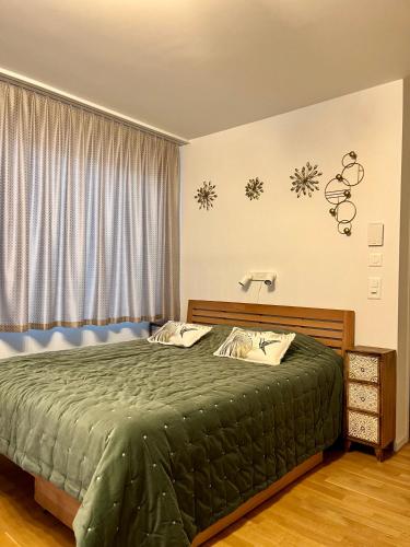 a bedroom with a green bed with snowflakes on the wall at Studio Horizon Dorigny in Lausanne