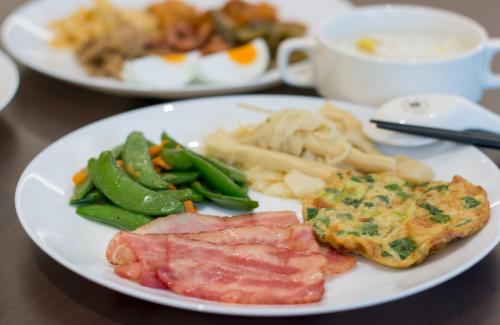 a plate of food with meat and vegetables on a table at Garden Spring Hotel in Jiaoxi