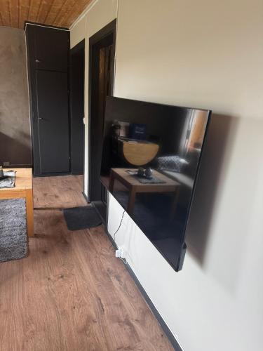 a living room with a tv on the wall at Linken Studio for 2 in Narvik