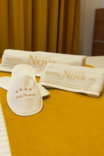 two white napkins sitting on top of a bed at Nova Sky Hotel in Erbil