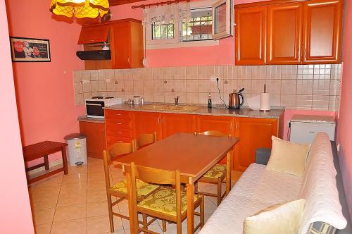 a small kitchen with a table and a couch at Studios Kostas & Despina in Lidia