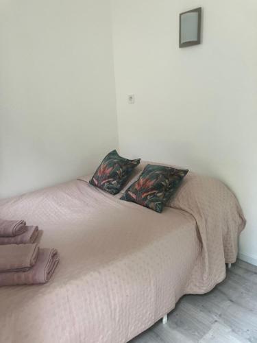 a bed with two pillows on it in a room at Villa Thyziri in Roquefort-les-Pins