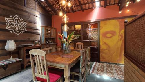 a dining room with a wooden table and chairs at Casa Encantada in Paraty
