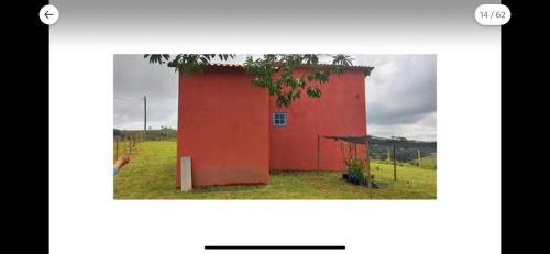 a red building in the middle of a field at Lavandário do Sertão in Gonçalves