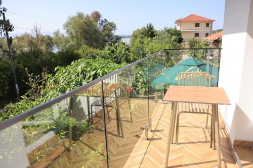 a balcony with a table and chairs on it at Villa Osmani in Shkodër