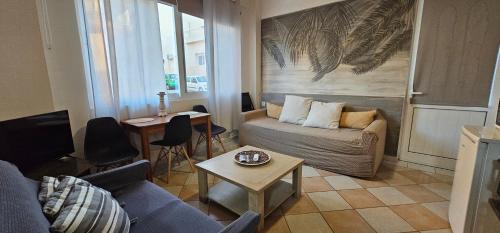 a living room with a couch and a table at KD Palm Home in Lávrion