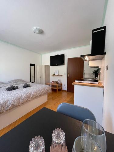 a room with a bed and a table with wine glasses at 4 Roses Residence in Sečovlje