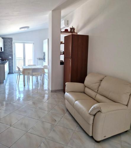 a living room with a couch and a table at Lodge Rosa in Agropoli