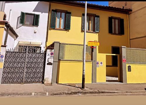 a yellow building with a street sign in front of it at Villa Caterina in Florence