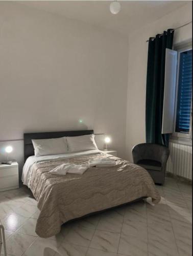 a bedroom with a large bed and a chair at Villa Caterina in Florence