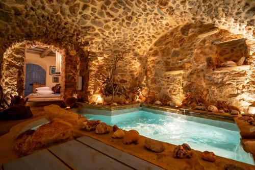a large indoor pool in a stone walled room at Aretis Stone Retreat 