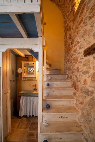 a staircase in a room with a stone wall at Aretis Stone Retreat 