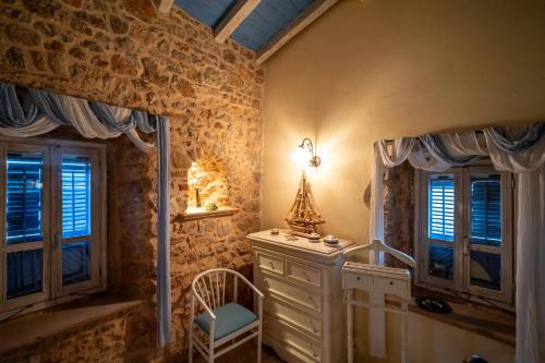 a bathroom with a sink and two windows at Aretis Stone Retreat 