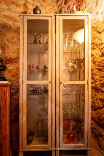 a cabinet with glass doors in a room at Aretis Stone Retreat 