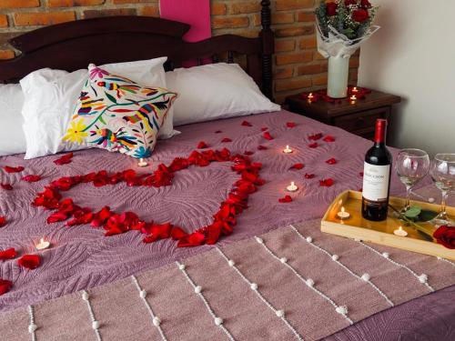 a bed with a heart made out of red roses at Casa Axixic in Ajijic