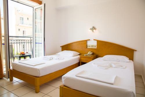 Posteľ alebo postele v izbe v ubytovaní Astali Hotel
