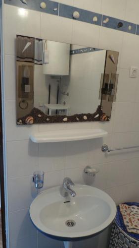 a bathroom with a sink and a mirror at Apartments Turina in Sveti Juraj