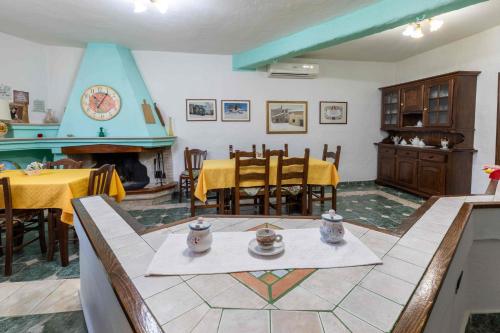 a living room with a table and a fireplace at B&b Gennargentu in Fonni