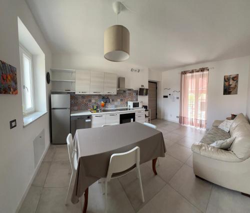 a kitchen and living room with a table and a couch at Casa Adele in Grugliasco