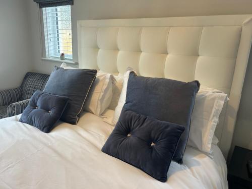 a large white bed with two pillows on it at Wendys house in Sarisbury Green