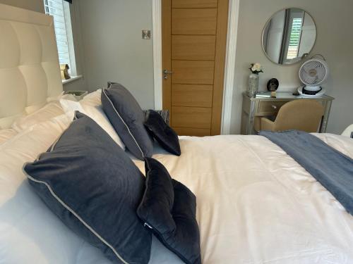 a bed with black pillows on it in a bedroom at Wendys house in Sarisbury Green