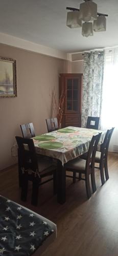 a dining room with a table with chairs and a tableablish at Apartament u Basi in Sanok