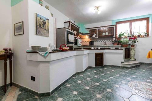 a large kitchen with a large counter top at B&b Gennargentu in Fonni