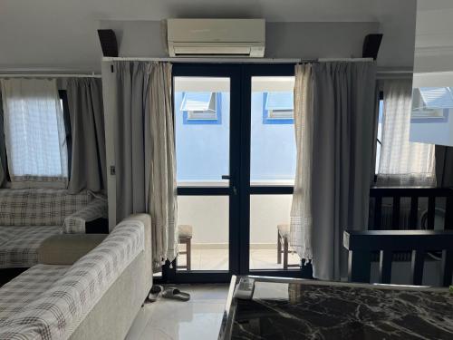 a living room with a couch and a window at Bodrum Center 2plus1 for 6 people - Citak Mansions in Bodrum City