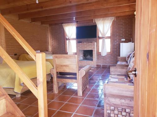 a room with a bed and a fireplace at Cabaña en El Zembo, Huasca de Ocampo in Huasca de Ocampo