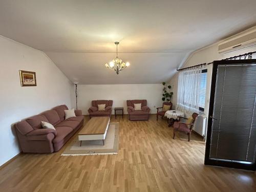 a living room with a couch and chairs and a table at Apartments Stećak in Sarajevo