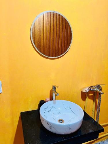 a bathroom with a sink and a mirror on a counter at Pura homestay in Yên Minh