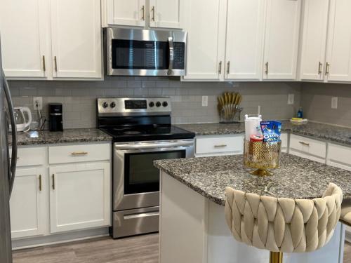 a kitchen with white cabinets and stainless steel appliances at Modern Stay in Killeen in Killeen