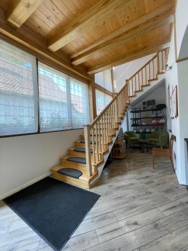 a living room with a staircase in a house at Munich Residence in Cristian