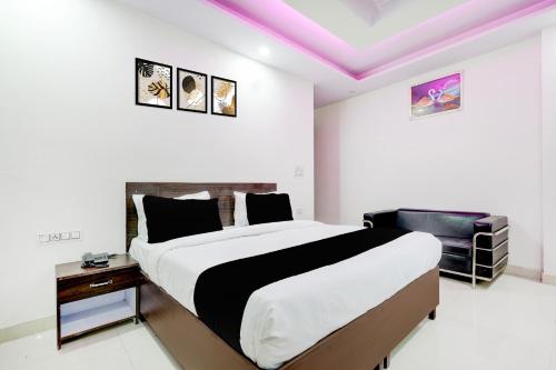 a bedroom with a large bed and a purple ceiling at FabHotel DD Green Residency in New Delhi