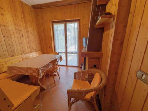 a dining room with a table and chairs and a window at Aprica Mountain Life in Aprica
