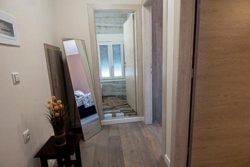 a hallway with a mirror next to a door at Ariadni in Kalloni