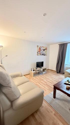 a living room with a couch and a tv at Apartmán Centrum in Martin