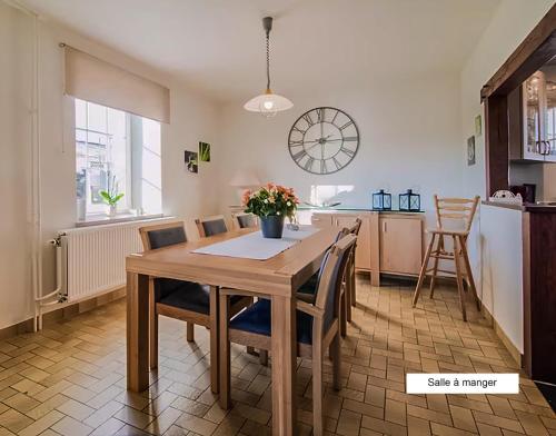 a kitchen and dining room with a wooden table and chairs at Gîte Chez Cyrille in Houffalize