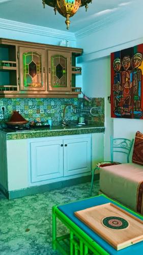 a kitchen with a couch and a table in a room at Riad SULTANA lateral seaview in Saidia 