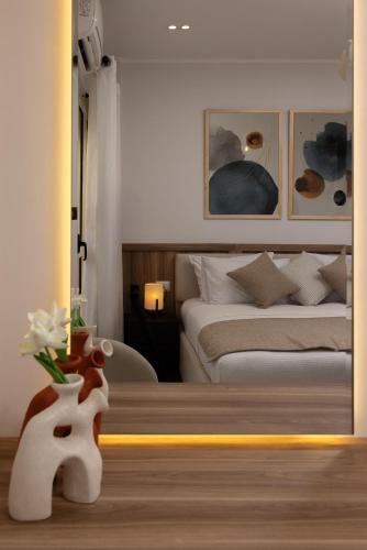 a bedroom with a bed and a vase with flowers in it at Marassi Views Direct on Pool 3BR Beach Access by Best of Bedz in El Alamein