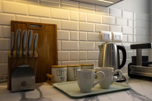 a counter with two coffee cups on a plate at Marassi Views Direct on Pool 3BR Beach Access by Best of Bedz in El Alamein