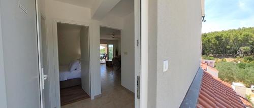 a bedroom with a bed and a view of a balcony at Villa Bell'Aria Korcula in Vela Luka