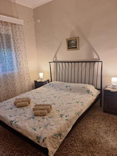 a bedroom with a bed with two pillows on it at Eva's house in Xanthi