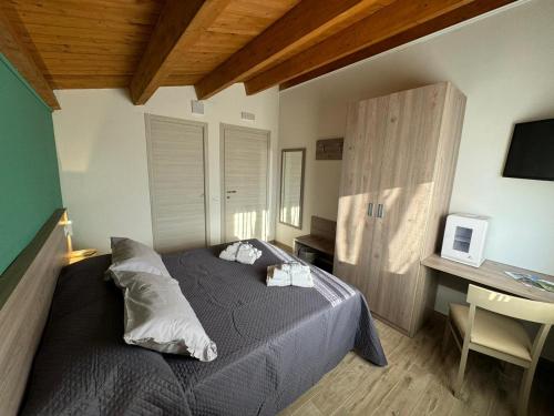 a bedroom with a bed and a desk with a computer at Come a Casa in Santa Maria del Cedro