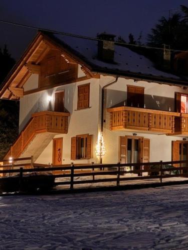 a large house with wooden balconies on the side of it at Chalet CHIARA&CARLO in Bormio