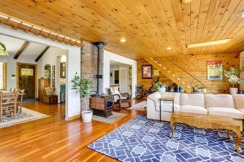 a living room with a couch and a wooden ceiling at Waterfront Home on White Lake Near Bethel Woods! in White Lake