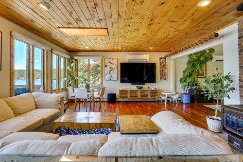 a living room with a couch and a tv at Waterfront Home on White Lake Near Bethel Woods! in White Lake