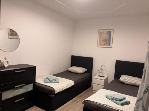 a room with two beds and a mirror at R&S Apartment in Graz