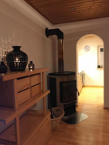 a living room with a wood burning stove in a room at Kleinbergsonne in Filzmoos