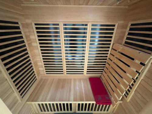 a view from the top of a room with a red bench at Kleinbergsonne in Filzmoos